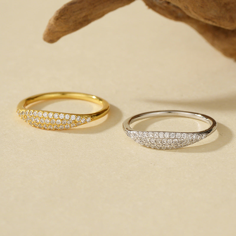 Women's 18K gold minimalist stacking ring on a natural background